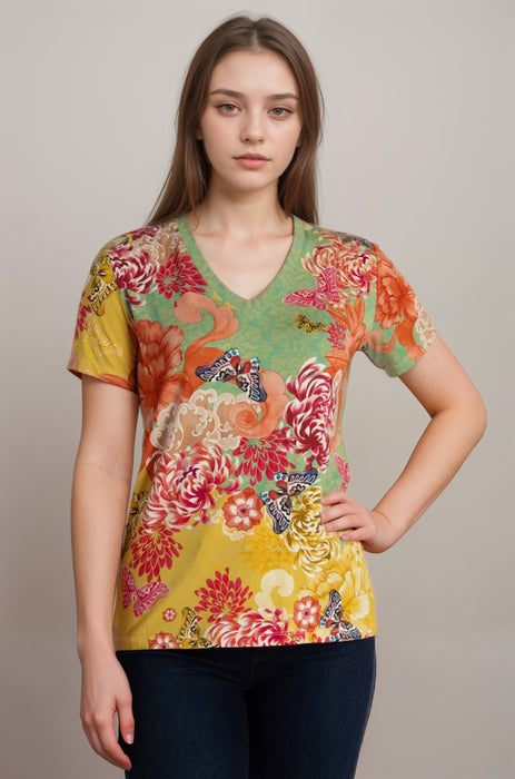 Woman wearing a colorful floral and butterfly patterned tee with v-neck from Johnny Was