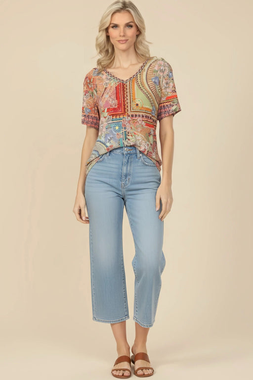 Woman wearing a colorful mosaic tile patterned tee with v-neck and short sleeves from Johnny Was