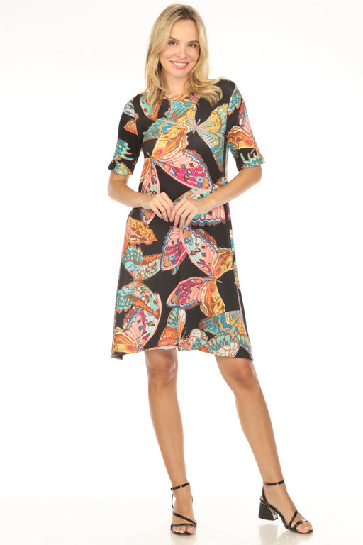 Woman wearing a black dress with colorful butterfly patterns and crew neck from Johnny Was