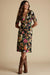 Woman wearing a black floral midi dress with v-neck and twist front detail from Johnny Was
