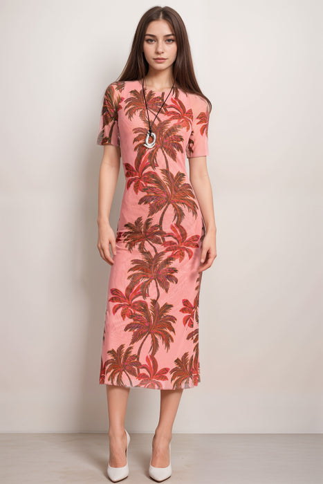 Woman wearing a pink midi mesh dress with palm tree pattern and short sleeves from Johnny Was