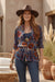 Woman wearing a button-down shirt with floral and geometric burnout pattern from Johnny Was