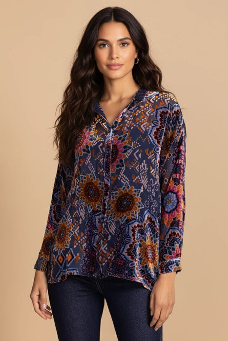 Woman wearing a button-down shirt with floral and geometric burnout pattern from Johnny Was