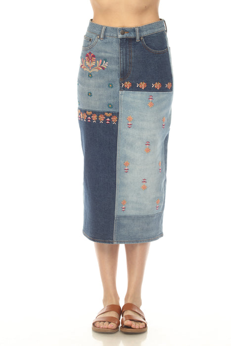 Woman wearing a patchwork denim midi pencil skirt with floral embroidery from Johnny Was