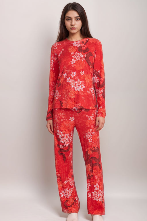 Woman wearing a matching red pajama set with florals and snake print