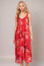 Woman wearing a red midi tank sleep dress with florals and snake print