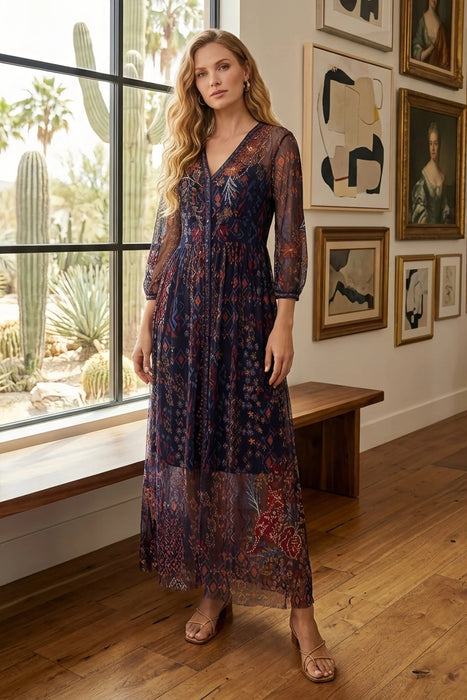 Woman wearing a printed and embroidered mesh maxi dress with v-neck and 3/4 bishop sleeves from Johnny Was