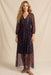Woman wearing a printed and embroidered mesh maxi dress with v-neck and 3/4 bishop sleeves from Johnny Was