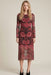 Woman wearing a red floral mesh midi dress with long sleeves from Johnny Was