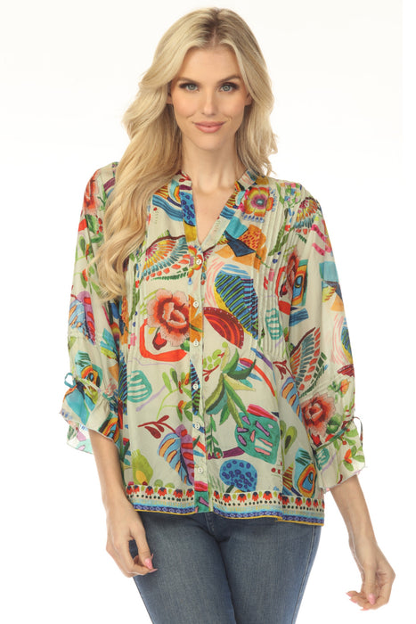 Woman wearing a colorful printed silk blouse with pintuck detailing and 3/4 tie cuff sleeves from Johnny Was