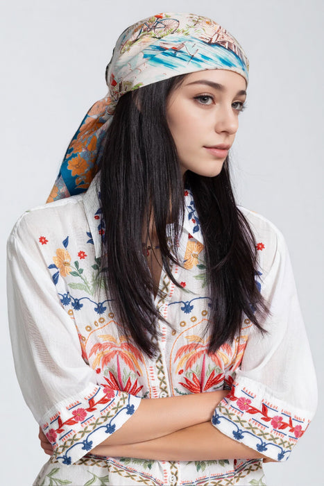 Woman wearing a colorful cotton printed head scarf from Johnny Was