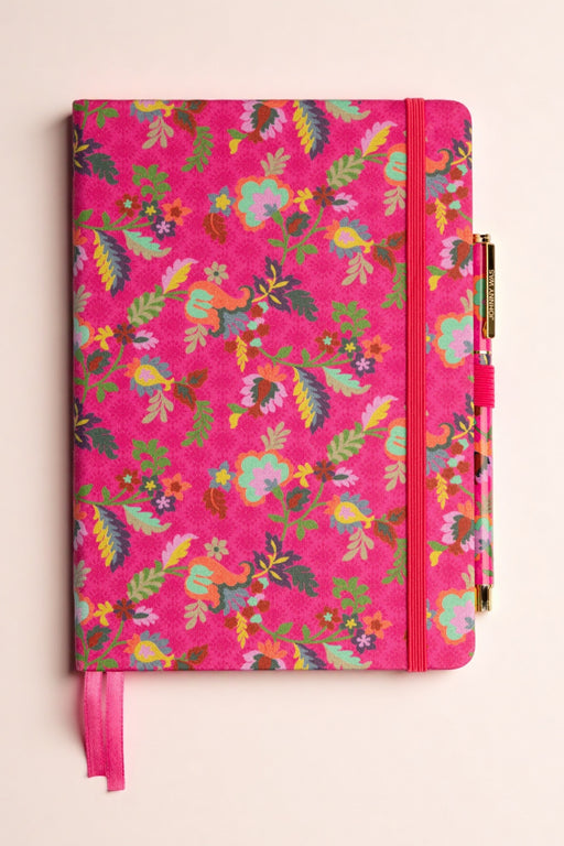 Pink floral-patterned notebook with matching pen from Johnny Was