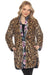 Woman wearing a leopard printjacket with floral trim