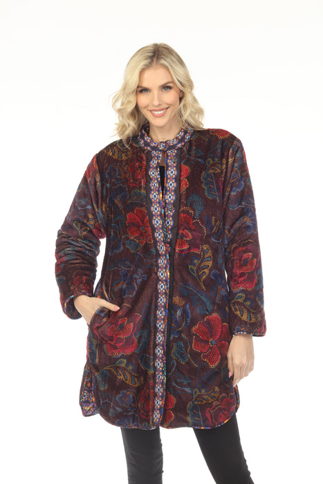 Woman wearing a colorful floral patterned reversible puffer jacket with snaps closure and side pockets from Johnny Was