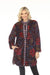 Woman wearing a colorful floral patterned reversible puffer jacket with snaps closure and side pockets from Johnny Was