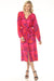 Woman wearing a vibrant pink tie-dye patterned midi dress with belt and button front from Johnny Was