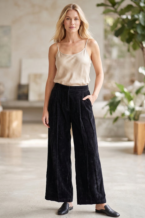 Woman wearing a black velvet corduroy pants with side pockets and wide leg from Johnny Was