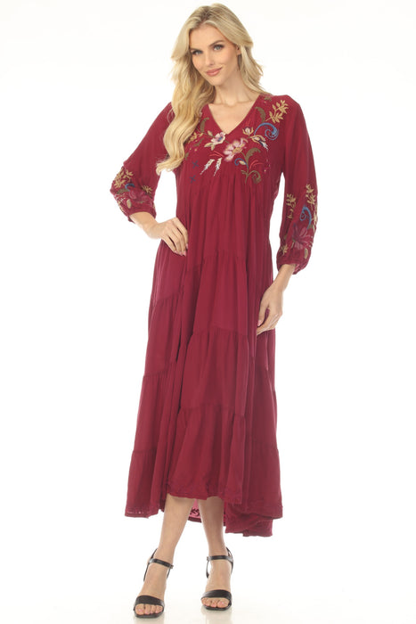 Woman wearing a burgundy dress with floral embroidery and tiered maxi skirt from Johnny Was