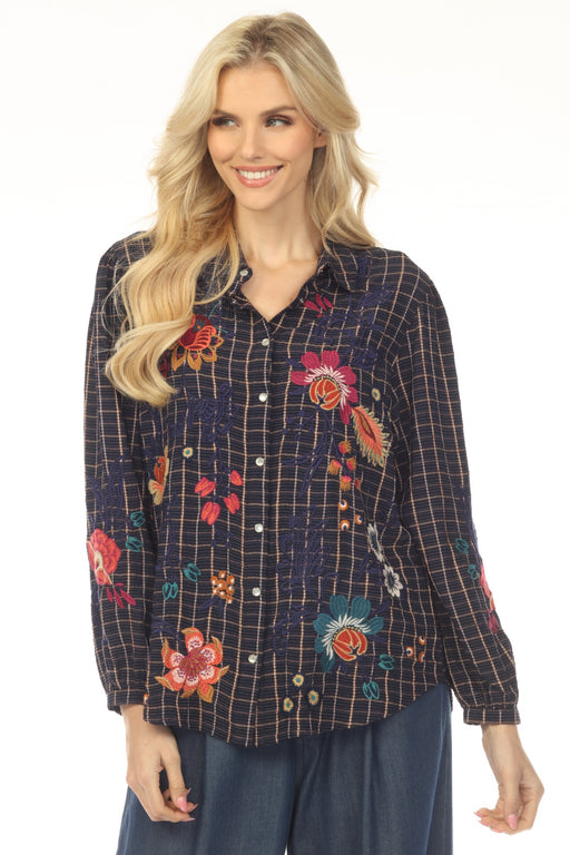 Woman wearing a dark blue plaid shirt with colorful floral embroidery from Johnny Was