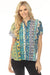 Woman wearing a colorful patterned shirt with dolman sleeves and button front from Johnny Was