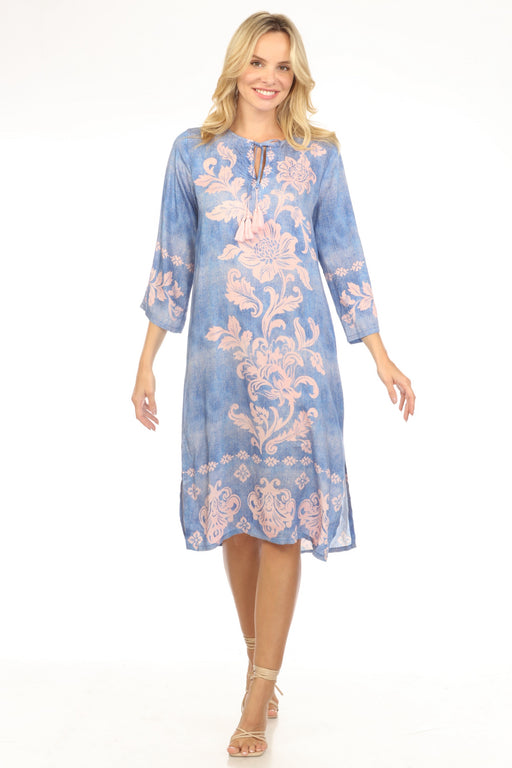 Woman wearing a blue midi kaftan dress with floral scroll pattern and kimono sleeves from Johnny Was