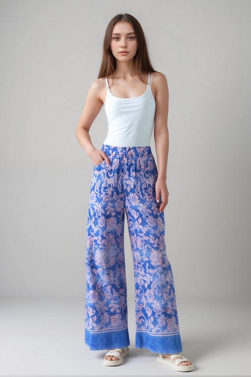 Woman wearing a wide leg pant with floral scroll pattern and elastic waist from Johnny Was