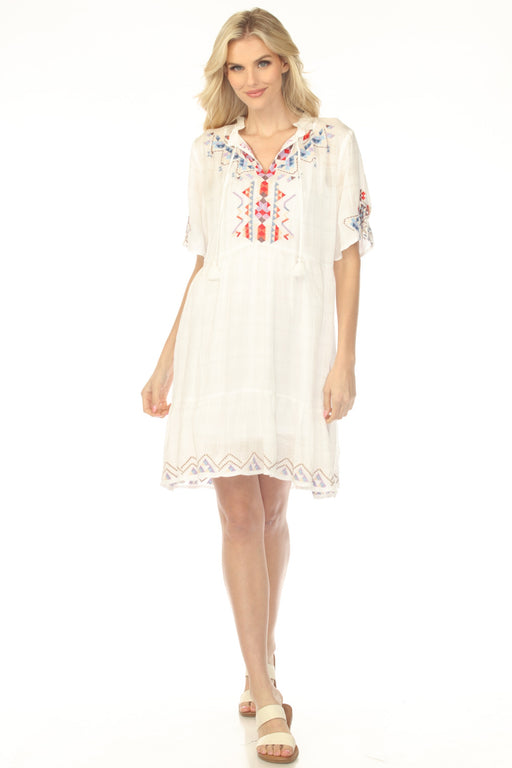Woman wearing a white dress with tonal plaid and vibrant geometric embroidery from Johnny Was