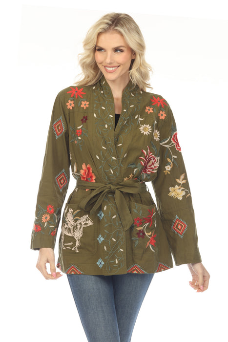 Woman wearing a green floral embroidered military style jacket with self-tie belt and side pockets from Johnny Was