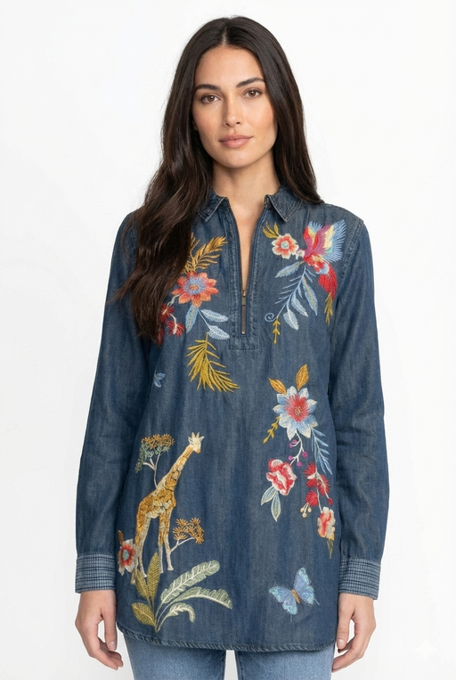 Woman wearing a denim shirt tunic with colorful floral and animal embroidery from Johnny Was