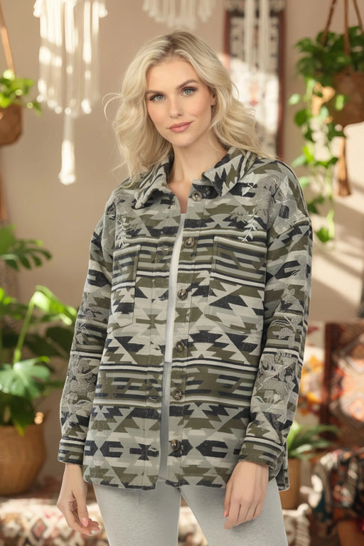 Woman wearing a woven jacket with Aztec pattern and floral embroidery from Johnny Was
