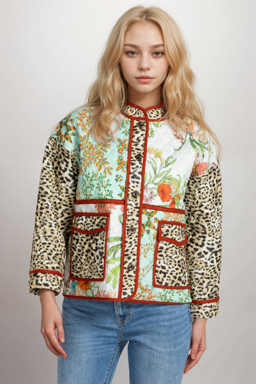 Woman wearing a quilted patterned jacket with animal print and floral design from Johnny Was