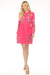 Woman wearing a pink floral embroidered shirt dress with long sleeves from Johnny Was