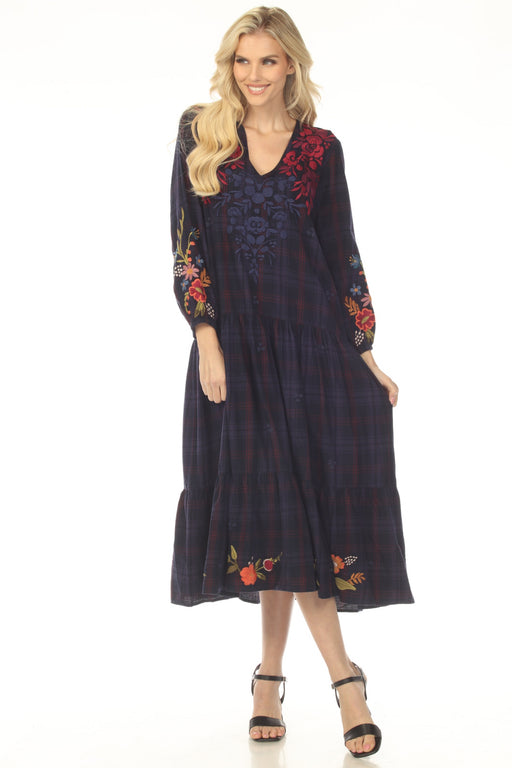 Woman wearing a dark blue plaid dress with floral embroidery and tiered midi skirt from Johnny Was