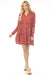 Woman wearing a red plaid tiered dress with floral embroidery from Johnny Was