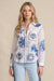Woman wearing white long sleeve shirt with blue embroideries from Johnny Was