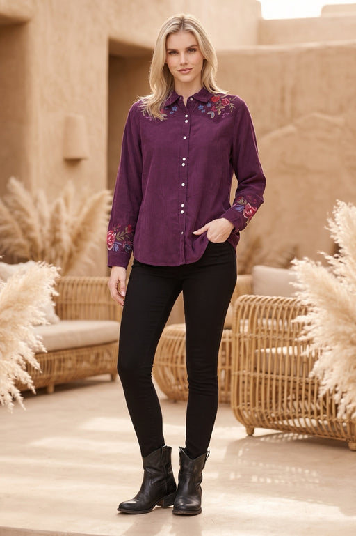 Woman wearing a purple long sleeve corduroy shirt with floral embroidery from Johnny Was