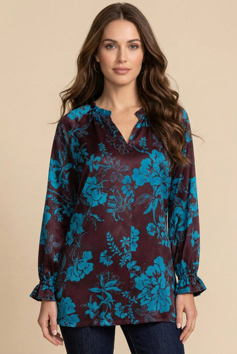 Woman wearing a two-tone floral printed tunic top with v-neck and long sleeves from Johnny Was