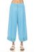 Woman wearing a blue linen culotte pant with embroidered crop hem from Johnny Was
