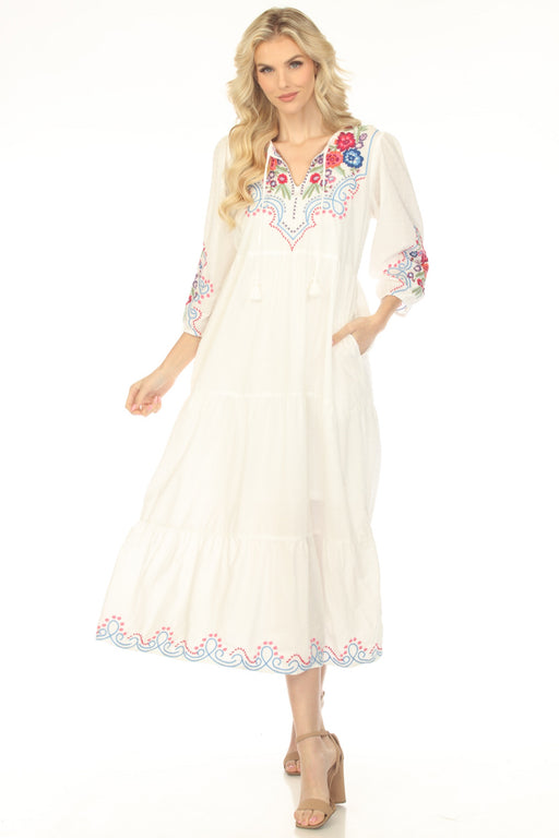 Woman wearing a white embroidered maxi dress with tasseled split v-neck and tiered skirt from Johnny Was