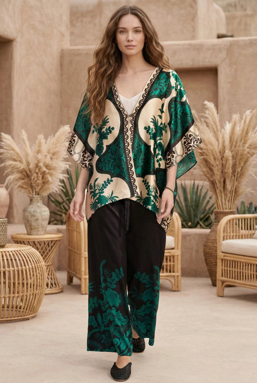 Woman wearing a black wide leg pant with green floral print from Johnny Was