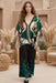 Woman wearing a black wide leg pant with green floral print from Johnny Was