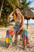 Woman wearing a colorful wide leg pants with side pockets and tropical floral print from Johnny Was