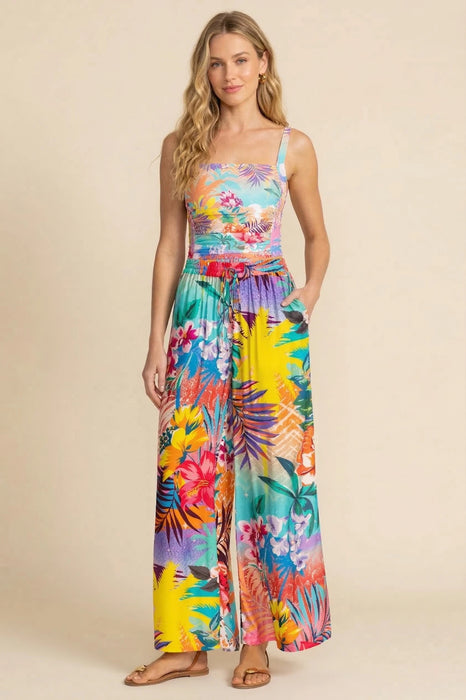 Woman wearing a colorful wide leg pants with side pockets and tropical floral print from Johnny Was