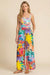 Woman wearing a colorful wide leg pants with side pockets and tropical floral print from Johnny Was
