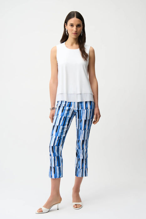Woman wearing Joseph Ribkoff abstract print crop pull-on pants, featuring a modern patterned design, cropped length, stretch fabric, and a flattering slim fit.