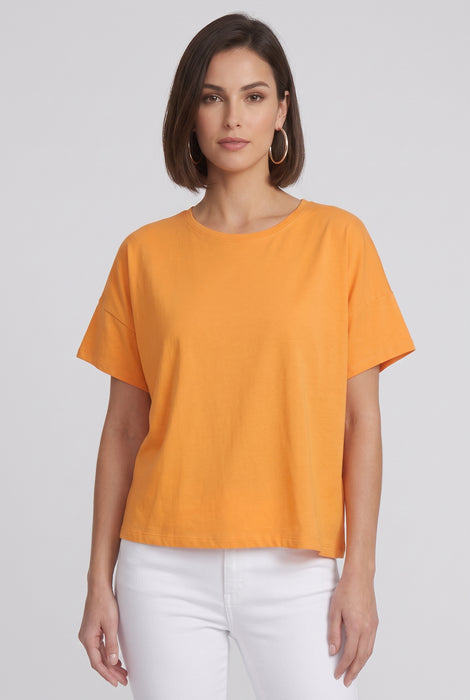 A woman modeling a short-sleeve, crew-neck orange top from Joseph Ribkoff