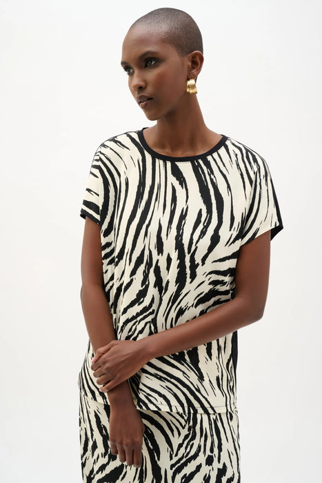 Woman wearing Joseph Ribkoff animal print silky knit back top for office outfit