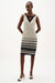 Woman wearing a sleeveless geometric print sheath dress with V-neck and keyhole detail, styled for office wear, business events, or modern chic evening occasions.