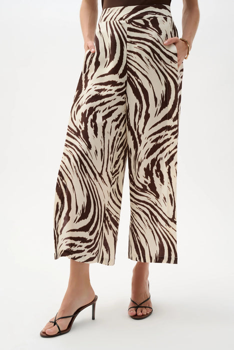 Woman wearing Joseph Ribkoff beige/brown animal print pleated culotte pants styled for resort vacation, brunch, summer outings, and elegant casual wear.