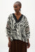 Woman wearing Joseph Ribkoff animal print poncho top for resort vacation outfit